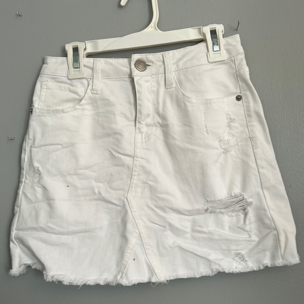 White denim skirt with rips